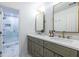 Bathroom with a double sink vanity, brass fixtures, and a marble walk-in shower at 2411 Charleston Oaks Ln, Decatur, GA 30030
