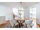 Bright dining room featuring hardwood floors, modern chandelier, and a kitchen view through a doorway at 2411 Charleston Oaks Ln, Decatur, GA 30030