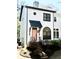 Charming two-story home with a light pink front door, neat landscaping and a stairway leading to the entrance at 2411 Charleston Oaks Ln, Decatur, GA 30030