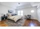 Spacious main bedroom with tray ceiling, hardwood floors, and a sitting area at 2411 Charleston Oaks Ln, Decatur, GA 30030