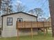 View of the home's backyard featuring a wood deck with support beams, grassy yard, and siding at 1330 Lanvale Sw Dr, Atlanta, GA 30310