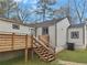 View of the home's backyard featuring a wood deck with stairs and a grassy yard at 1330 Lanvale Sw Dr, Atlanta, GA 30310