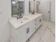 Bathroom with double sink vanity, white marble countertop, white cabinets, and tile floors at 1330 Lanvale Sw Dr, Atlanta, GA 30310