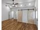 Spacious bedroom featuring high ceilings, hardwood floors, ceiling fan, and sliding barn doors at 1330 Lanvale Sw Dr, Atlanta, GA 30310
