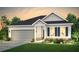 Charming one-story home with a two-car garage, manicured lawn, and beautiful landscaping at 2098 Amaryllis Dr, Grayson, GA 30017