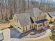 Aerial view of the house with a two-car garage and mature trees at 215 Morning Glory Rdg, Canton, GA 30115