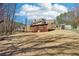 A lush backyard and the home's exterior and screened porch, surrounded by mature trees at 215 Morning Glory Rdg, Canton, GA 30115