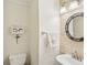 Powder room features brick accent wall, decorative mirror, and pedestal sink at 215 Morning Glory Rdg, Canton, GA 30115