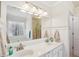 Bright bathroom features double vanity, soaking tub, glass shower, and large mirror at 215 Morning Glory Rdg, Canton, GA 30115