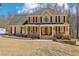 Charming two-story home with a welcoming front porch, manicured lawn, and classic architectural details at 215 Morning Glory Rdg, Canton, GA 30115