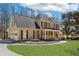 Lovely two-story home with a manicured lawn, a welcoming front porch, and a classic architectural style at 215 Morning Glory Rdg, Canton, GA 30115