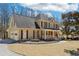 Beautiful two-story home with a manicured lawn and a cozy front porch, perfect for relaxing outdoors at 215 Morning Glory Rdg, Canton, GA 30115