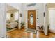 Bright foyer showcasing hardwood floors, a decorative door, and an open view to the living room at 215 Morning Glory Rdg, Canton, GA 30115