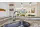 Kitchen with granite counter tops and stainless steel sink overlooking a comfortable living room at 215 Morning Glory Rdg, Canton, GA 30115
