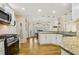 Updated kitchen featuring granite countertops, stainless steel appliances and an open, eat-in design at 215 Morning Glory Rdg, Canton, GA 30115