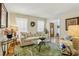 Bright living room featuring a comfortable sofa, area rug, and a decorative wreath at 215 Morning Glory Rdg, Canton, GA 30115