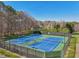 Outdoor tennis courts surrounded by lush trees offers a great way to stay active and enjoy the outdoors at 215 Morning Glory Rdg, Canton, GA 30115