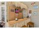 An outdoor tiki bar featuring fun signage, wicker, a wooden countertop, and seating for entertaining guests at 215 Morning Glory Rdg, Canton, GA 30115