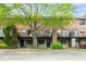 Charming brick townhouse with a mature tree in the front, offering a blend of classic style and natural beauty at 3087 Colonial Way # J, Atlanta, GA 30341