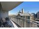 Balcony with seating offers cityscape views of neighboring buildings and the tree canopy beyond at 3338 Peachtree Ne Rd # 2405, Atlanta, GA 30326