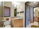 Well-lit bathroom with granite counters, wood cabinets, and a separate shower area at 3338 Peachtree Ne Rd # 2405, Atlanta, GA 30326