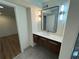 Well-lit bathroom with modern vanity, frameless mirror, tile floors, and a glass-enclosed shower at 2126 Jernigan Se Dr, Atlanta, GA 30315