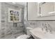 Updated bathroom with marble tile, glass enclosed shower, and modern vanity at 2126 Jernigan Se Dr, Atlanta, GA 30315