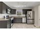 Beautifully updated kitchen with stainless steel appliances, granite countertops, and tile flooring at 2126 Jernigan Se Dr, Atlanta, GA 30315