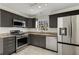 Updated kitchen with stainless steel appliances, granite countertops, and sleek gray cabinetry at 2126 Jernigan Se Dr, Atlanta, GA 30315