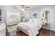Bright bedroom with hardwood floors, neutral walls, and a ceiling fan that adds a touch of elegance and comfort at 2449 Suwanee Pointe Dr, Lawrenceville, GA 30043
