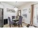 Dining area features a glass table, gray chairs, and a modern chandelier at 2449 Suwanee Pointe Dr, Lawrenceville, GA 30043