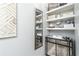 Dressing area offers storage and a stylish place to prepare for the day with a decorative mirror and open shelving at 2449 Suwanee Pointe Dr, Lawrenceville, GA 30043
