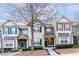 Charming townhomes featuring manicured landscaping, covered entrances, and diverse architectural details at 2449 Suwanee Pointe Dr, Lawrenceville, GA 30043