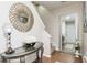 Welcoming hallway featuring a console table and decorative mirror which complements the aesthetic of the home at 2449 Suwanee Pointe Dr, Lawrenceville, GA 30043