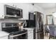 Close-up of kitchen with stainless steel appliances and grey backsplash at 2449 Suwanee Pointe Dr, Lawrenceville, GA 30043
