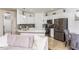 Open kitchen featuring stainless steel appliances, white cabinets, and a breakfast bar overlooking the living area at 2449 Suwanee Pointe Dr, Lawrenceville, GA 30043