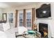 Comfortable living room with a fireplace, large windows, and inviting seating arrangements at 2449 Suwanee Pointe Dr, Lawrenceville, GA 30043