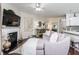 Spacious living area showcasing fireplace, hardwood floors, and seamlessly connected kitchen at 2449 Suwanee Pointe Dr, Lawrenceville, GA 30043
