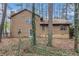 Backyard view featuring a wooded landscape, a door, and mature trees at 444 Wellington Way, Jonesboro, GA 30238