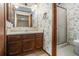 Bathroom featuring floral wallpaper, a vanity with sink, and a shower with glass door at 444 Wellington Way, Jonesboro, GA 30238