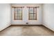 Bedroom boasting natural light from two windows, carpeted floor and neutral colored walls at 444 Wellington Way, Jonesboro, GA 30238