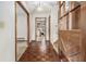 Entryway showcasing parquet flooring, a staircase, and glimpses of the kitchen, blending classic style at 444 Wellington Way, Jonesboro, GA 30238