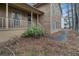 View of a home's front porch and wood siding, showing its cozy curb appeal within a lush, natural setting at 444 Wellington Way, Jonesboro, GA 30238