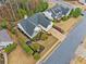 Charming home with landscaped yard; aerial view shows roof and surrounding community at 455 Ellesmere Way, Buford, GA 30518