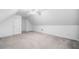 Bright finished attic with neutral carpet and a ceiling fan at 455 Ellesmere Way, Buford, GA 30518