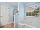 Relaxing bathroom with a soaking tub, glass-enclosed shower, and a window at 455 Ellesmere Way, Buford, GA 30518