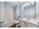 Well-lit bathroom with a tub, shower, vanity, and stylish light fixture at 455 Ellesmere Way, Buford, GA 30518