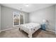 Bright bedroom featuring plush carpet, a neutral color palette, and a large window at 455 Ellesmere Way, Buford, GA 30518