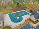 Aerial shot of community pool, covered for the season and surrounded by trees at 455 Ellesmere Way, Buford, GA 30518
