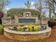 Elegant stone sign for Lenox Park community with colorful floral display at 455 Ellesmere Way, Buford, GA 30518